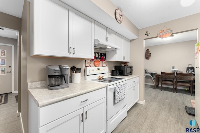 kitchen featuring white cabinets, white electric range oven, and light hardwood / wood-style floors