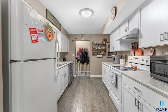 kitchen with light hardwood / wood-style floors, white appliances, and white cabinets