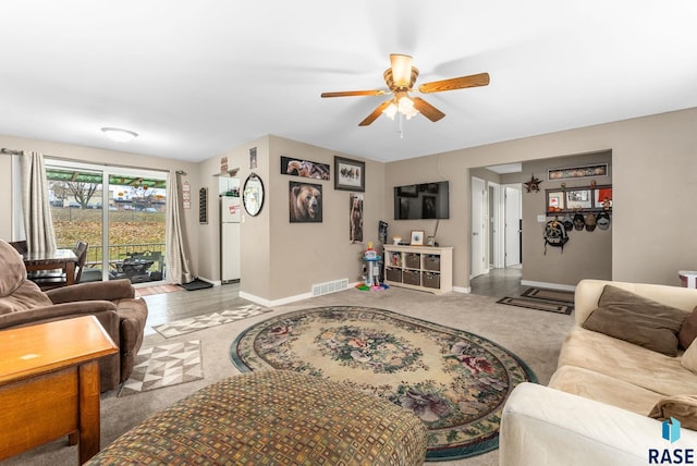 living room featuring light carpet and ceiling fan