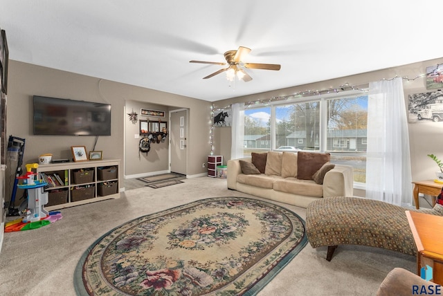 carpeted living room featuring ceiling fan