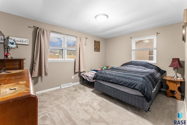 carpeted bedroom with a textured ceiling