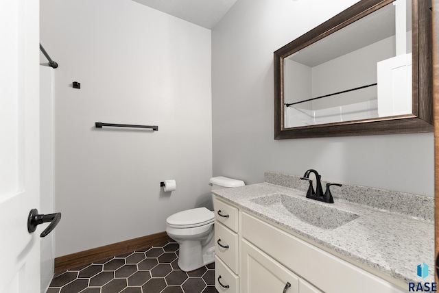 bathroom featuring toilet and vanity