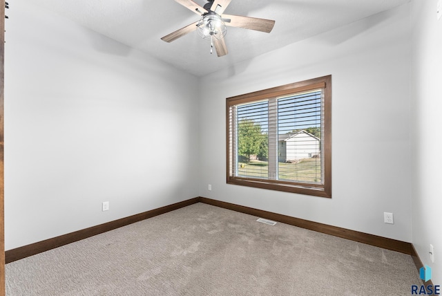 empty room featuring light carpet and ceiling fan