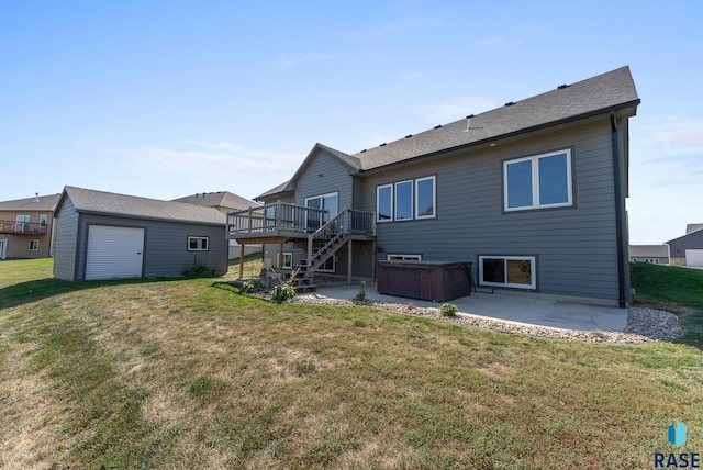 rear view of house featuring a patio area, a wooden deck, a yard, and an outbuilding