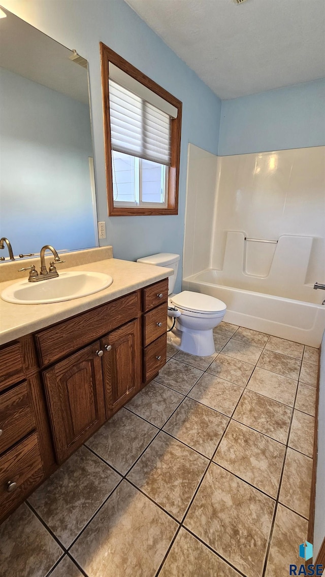 bathroom with tile patterned floors, toilet, and vanity