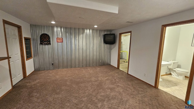 interior space featuring a textured ceiling and carpet