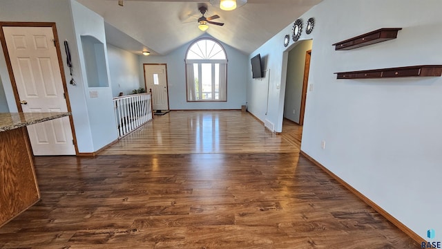 entryway with ceiling fan, dark hardwood / wood-style flooring, and lofted ceiling