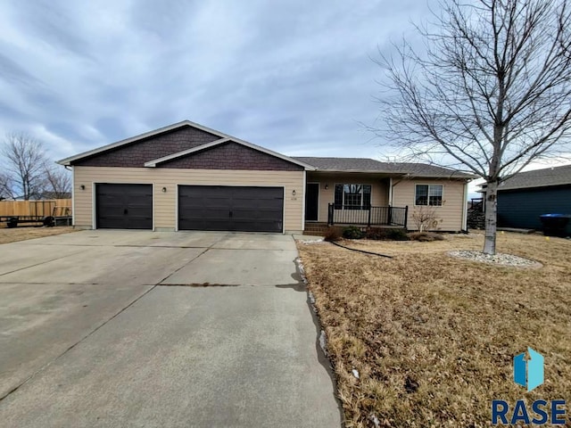 single story home featuring a garage and a porch