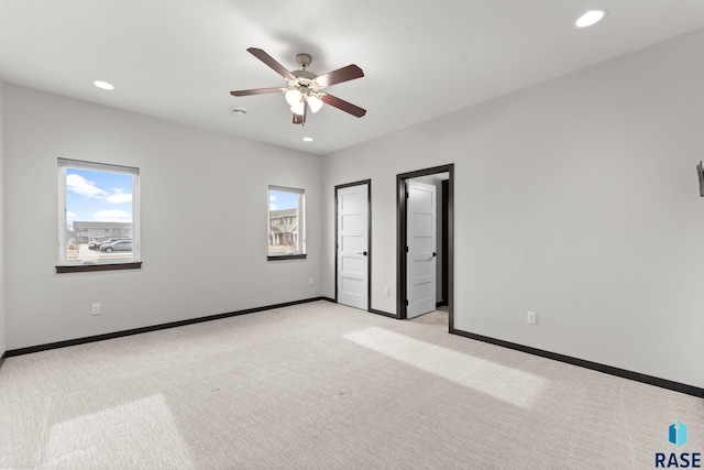 unfurnished bedroom with light carpet and ceiling fan