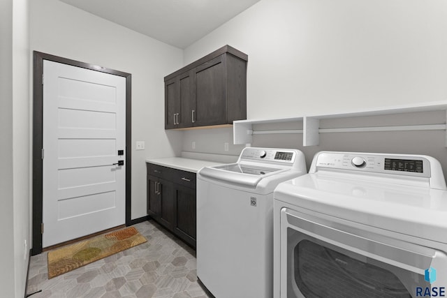 washroom with cabinets and washer and clothes dryer