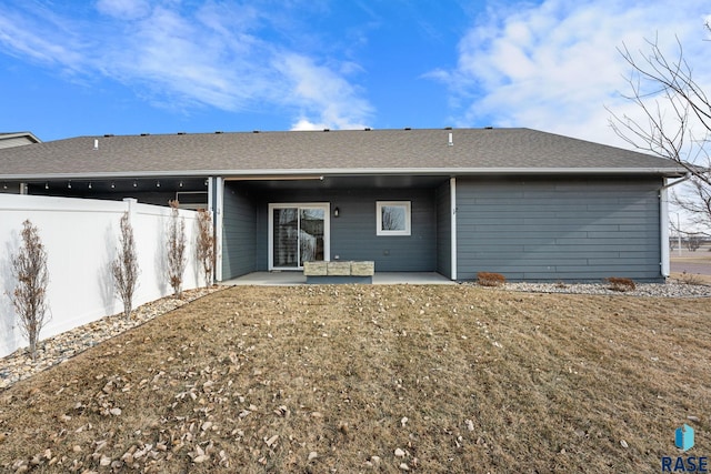 back of house featuring a patio area and a yard