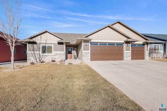 craftsman-style house with a front yard and a garage