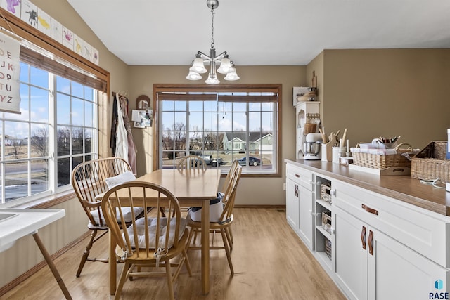 dining room featuring a notable chandelier and light hardwood / wood-style floors