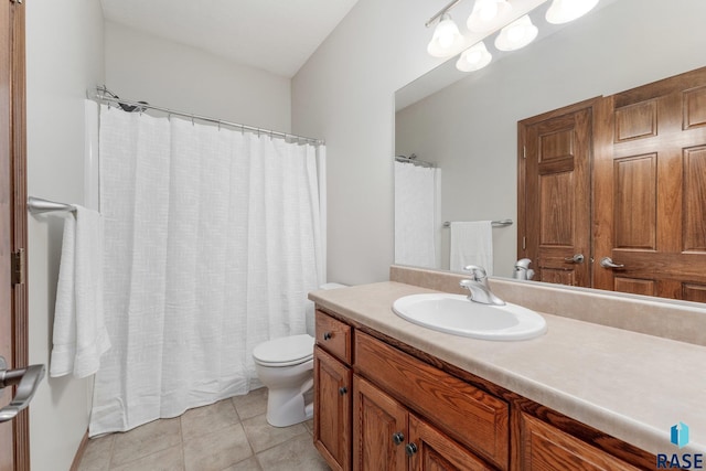 bathroom featuring toilet, tile patterned floors, and vanity