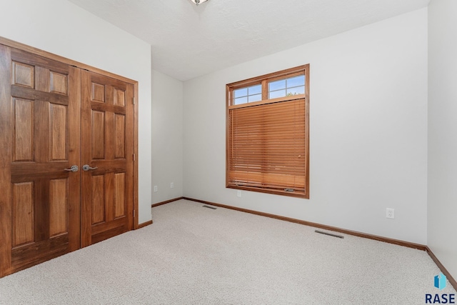 unfurnished bedroom featuring carpet