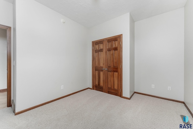 unfurnished bedroom with light colored carpet