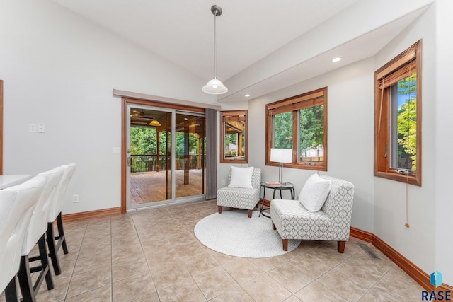 living area featuring light tile patterned floors and lofted ceiling