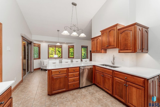 kitchen with dishwasher, light tile patterned floors, sink, decorative light fixtures, and kitchen peninsula