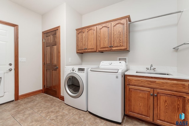 laundry room featuring cabinets, sink, light tile patterned floors, and independent washer and dryer