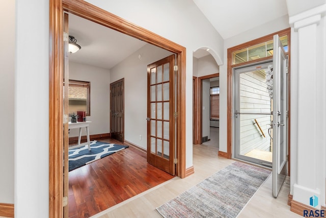 foyer entrance with lofted ceiling, light hardwood / wood-style flooring, and a wealth of natural light