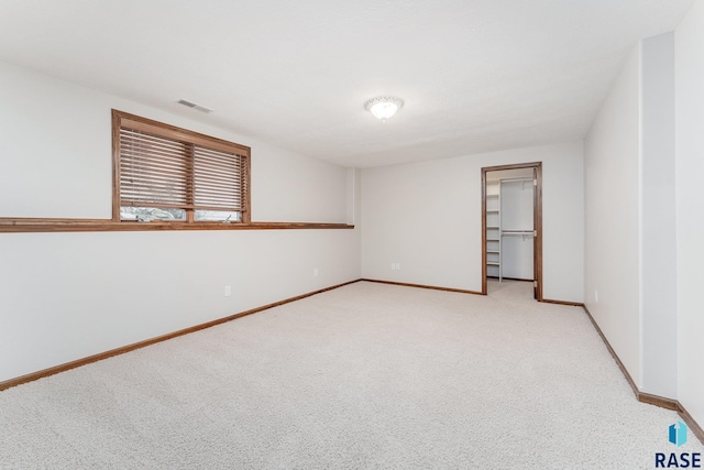 unfurnished room with light carpet