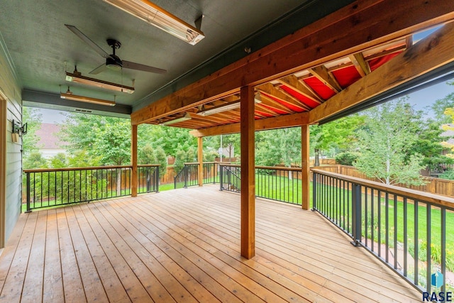 wooden deck featuring ceiling fan and a yard