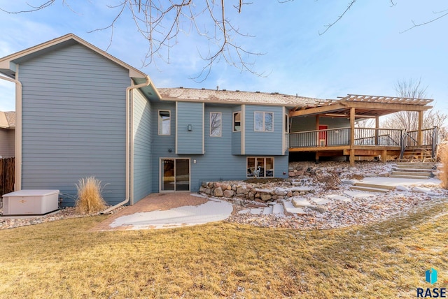 back of property with a deck, a pergola, a lawn, and a patio