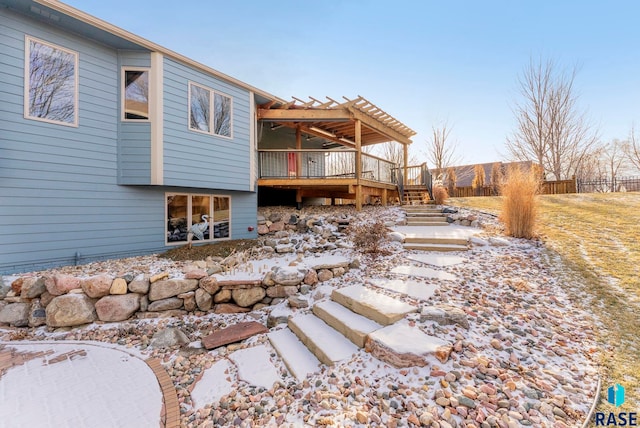 snow covered house with a wooden deck