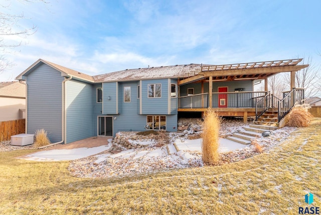 back of house featuring a deck, a patio area, and a yard