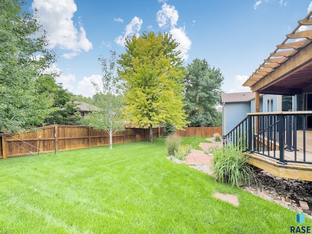 view of yard with a wooden deck and a patio