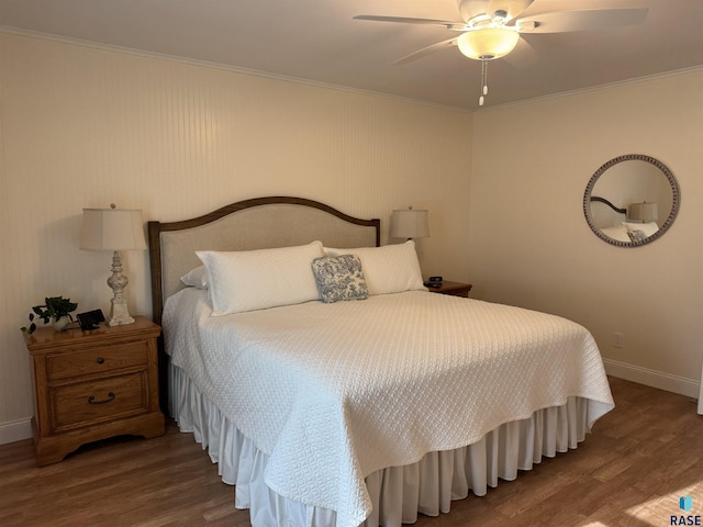 bedroom with ceiling fan, crown molding, and hardwood / wood-style flooring