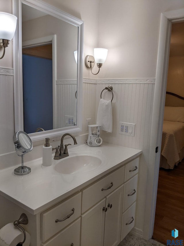 bathroom with hardwood / wood-style floors and vanity