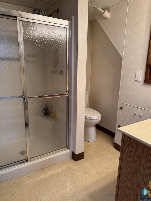 bathroom featuring walk in shower, vanity, and toilet