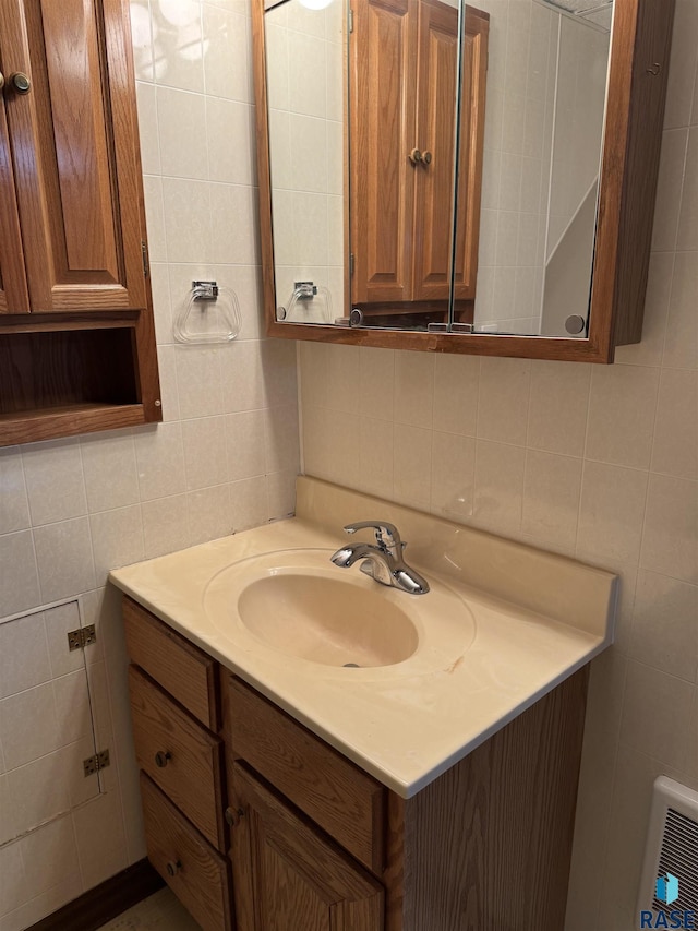 bathroom featuring tasteful backsplash, vanity, and tile walls