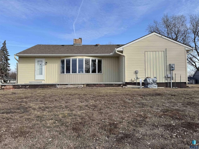 rear view of house with a lawn