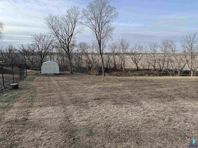 view of yard with a rural view and a shed