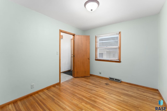 unfurnished room with light hardwood / wood-style flooring