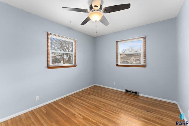 spare room featuring ceiling fan and light hardwood / wood-style floors