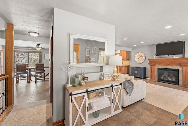 tiled living room featuring ceiling fan