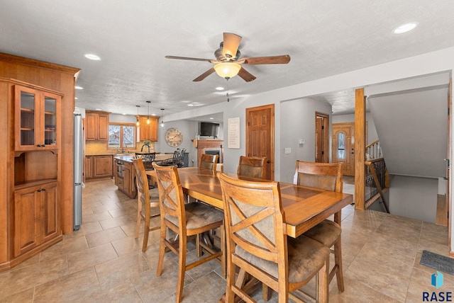 dining space featuring ceiling fan and sink