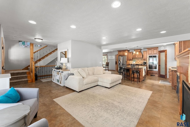 tiled living room featuring a textured ceiling