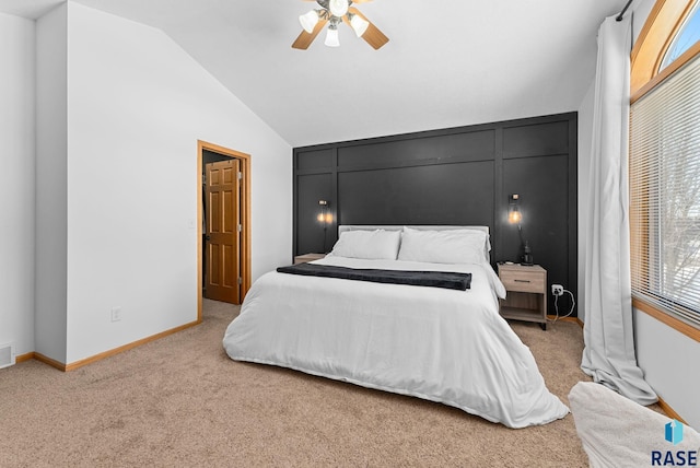 bedroom featuring ceiling fan, light colored carpet, and vaulted ceiling