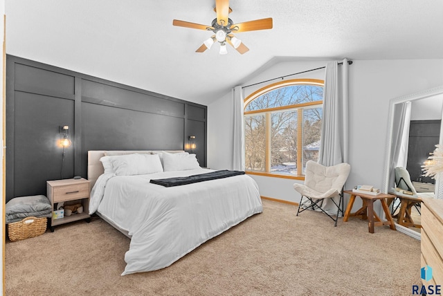 carpeted bedroom featuring ceiling fan and vaulted ceiling