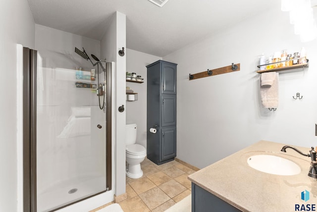 bathroom featuring vanity, toilet, tile patterned floors, and a shower with door