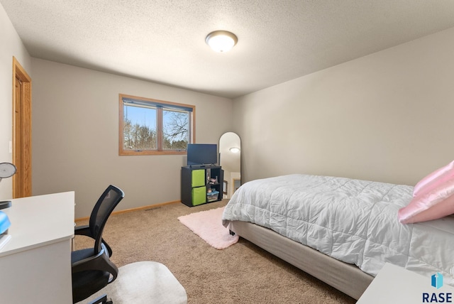 bedroom with a textured ceiling and carpet floors