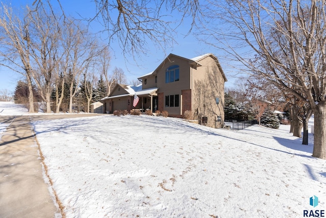 view of snow covered rear of property