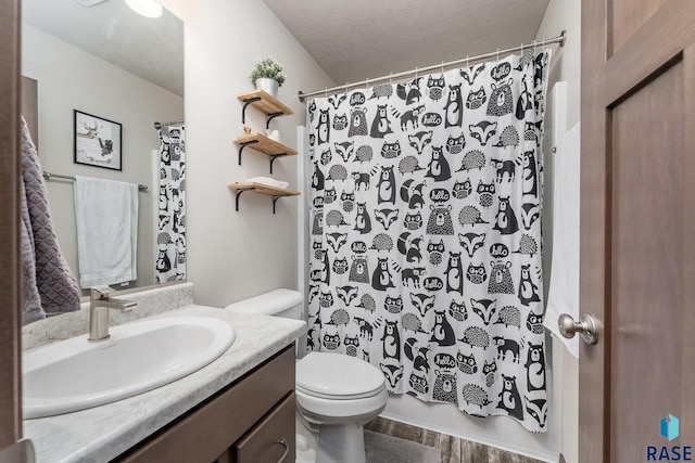 bathroom with a textured ceiling, toilet, wood-type flooring, and vanity