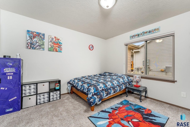 carpeted bedroom featuring a textured ceiling