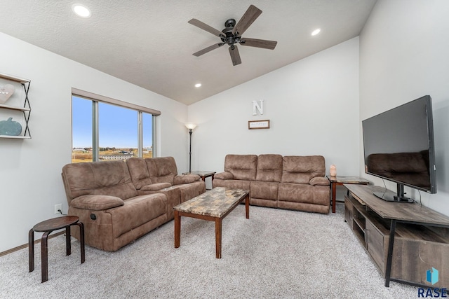 carpeted living room with ceiling fan, a textured ceiling, and vaulted ceiling