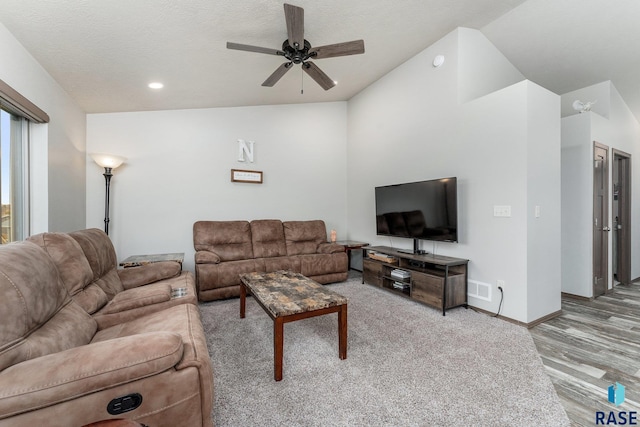 living room with ceiling fan and lofted ceiling